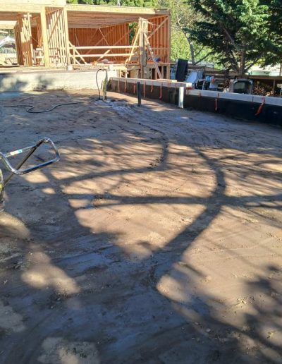 reinforced concrete retaining wall with integrated steps and entrance, built for soil retention and custom property access.